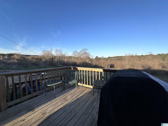 wooden terrace with a grill