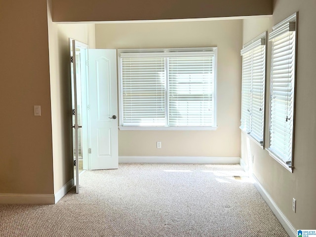 interior space with light colored carpet and baseboards