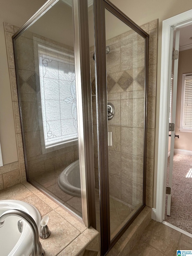 bathroom with tile patterned floors, a shower stall, and a bath