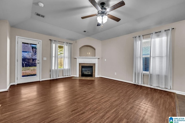 unfurnished living room with lofted ceiling, wood finished floors, and visible vents