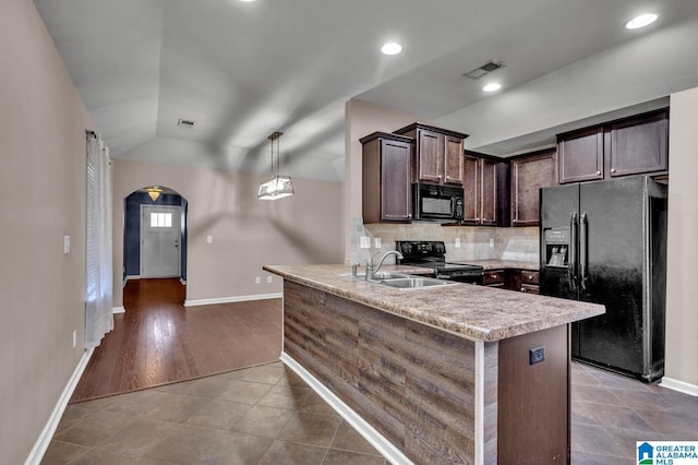 kitchen with arched walkways, visible vents, dark brown cabinets, light countertops, and black appliances