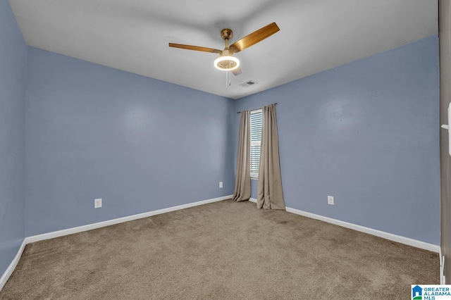 unfurnished room featuring baseboards, carpet flooring, visible vents, and a ceiling fan