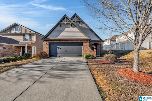 view of front of house featuring driveway, an attached garage, fence, and brick siding