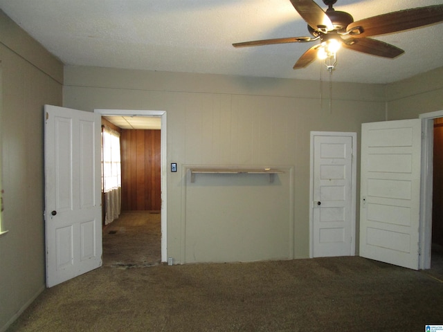 unfurnished bedroom featuring a ceiling fan and carpet