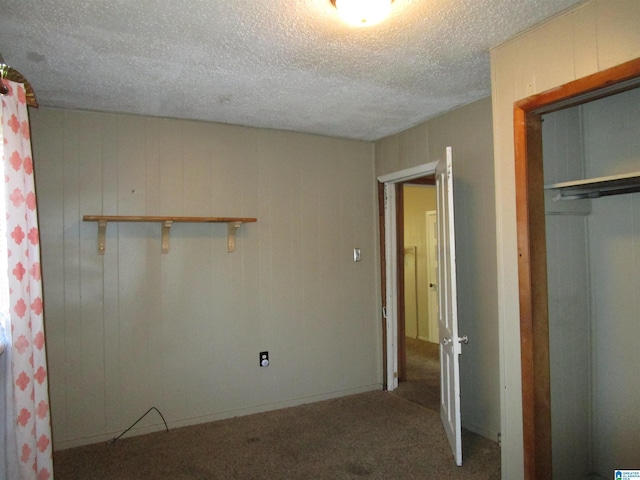 unfurnished bedroom with a closet, carpet flooring, and a textured ceiling