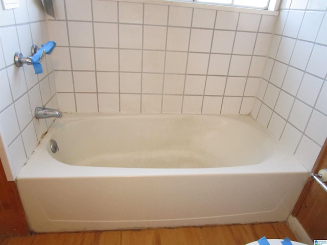 bathroom featuring a tub and wood finished floors