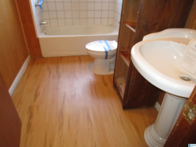 bathroom with toilet and wood finished floors