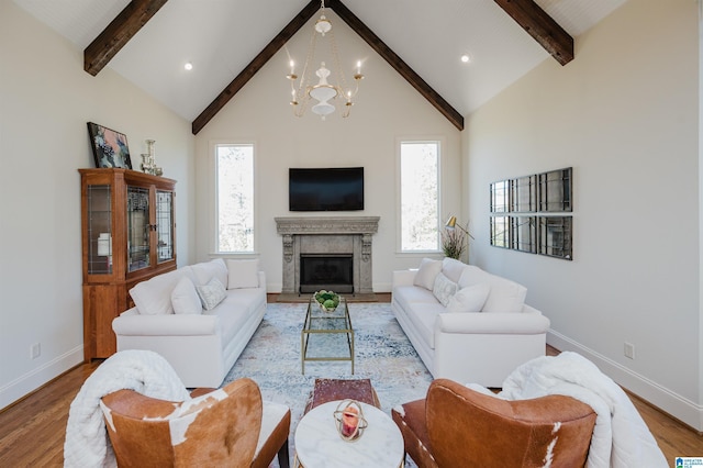 living area featuring high vaulted ceiling, beam ceiling, and light wood-style floors