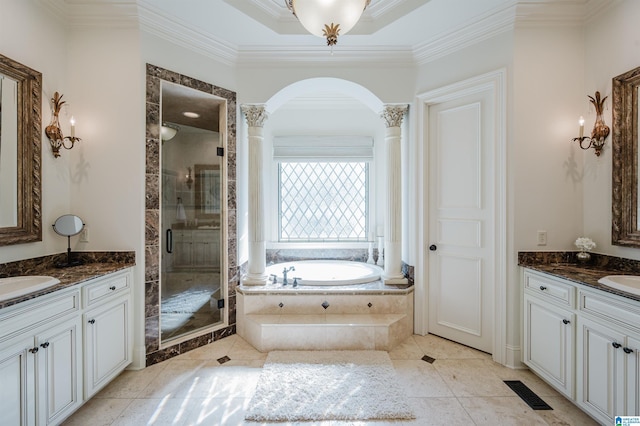 full bath featuring a garden tub, a sink, two vanities, a stall shower, and crown molding