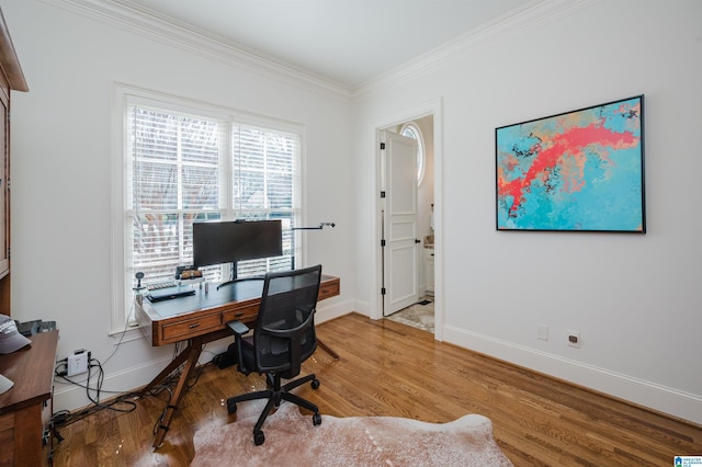 office area with crown molding, baseboards, and wood finished floors