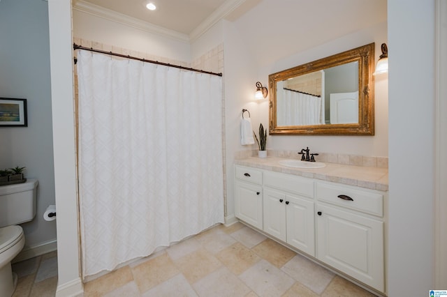 bathroom with ornamental molding, vanity, toilet, and baseboards