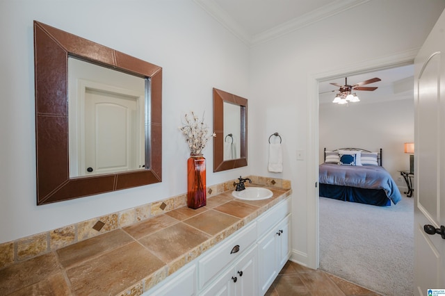 ensuite bathroom with ceiling fan, ornamental molding, connected bathroom, and vanity