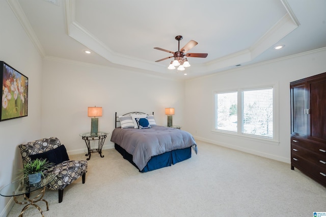 bedroom featuring recessed lighting, light colored carpet, baseboards, ornamental molding, and a tray ceiling