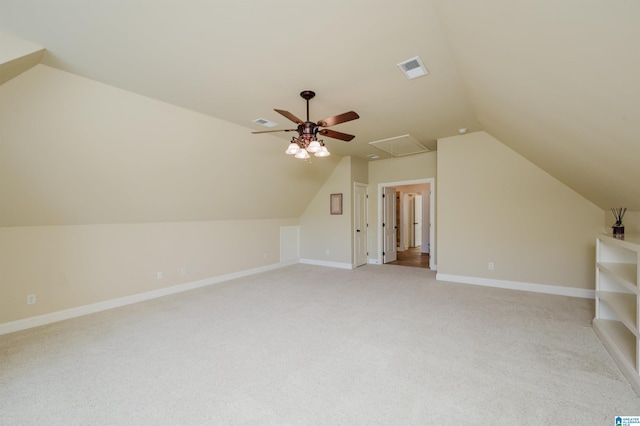 bonus room featuring lofted ceiling, visible vents, attic access, light carpet, and baseboards