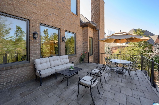 view of patio featuring a balcony and an outdoor living space