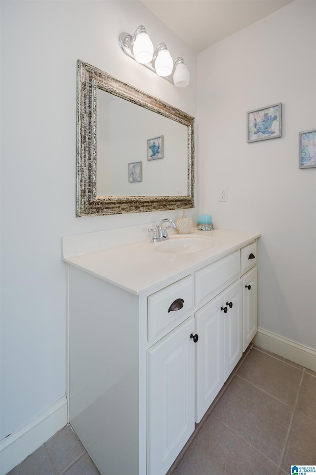 bathroom with vanity, baseboards, and tile patterned floors