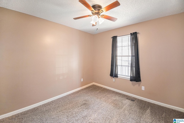 empty room featuring a textured ceiling, carpet floors, visible vents, and baseboards