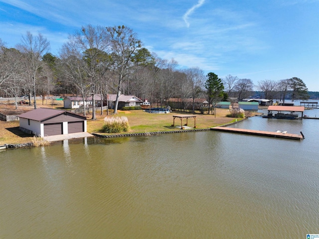 view of dock with a lawn and a water view