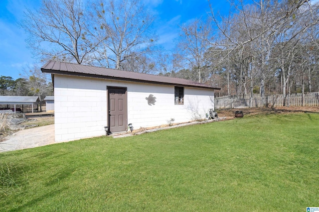 view of outbuilding featuring an outbuilding and fence