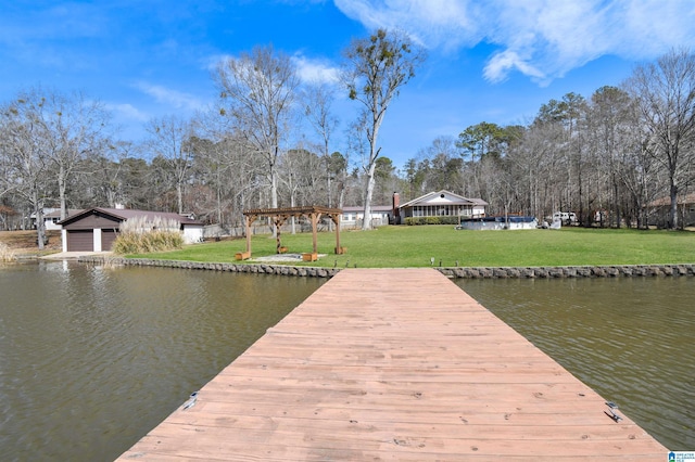 view of dock with a lawn and a water view