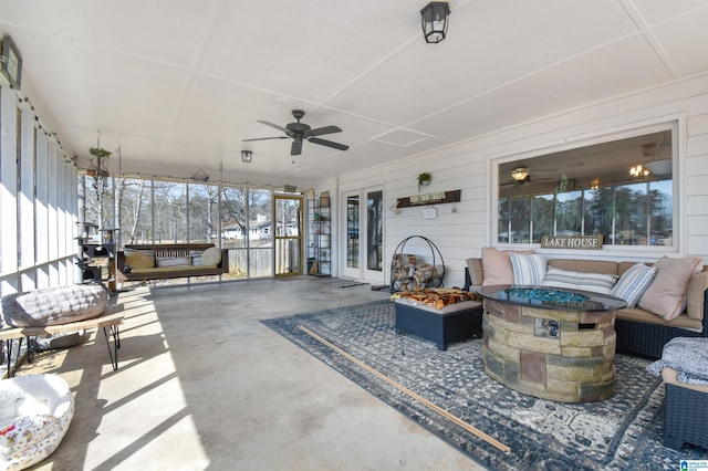 sunroom / solarium featuring ceiling fan