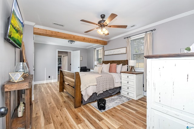 bedroom with light wood-type flooring, visible vents, crown molding, and baseboards