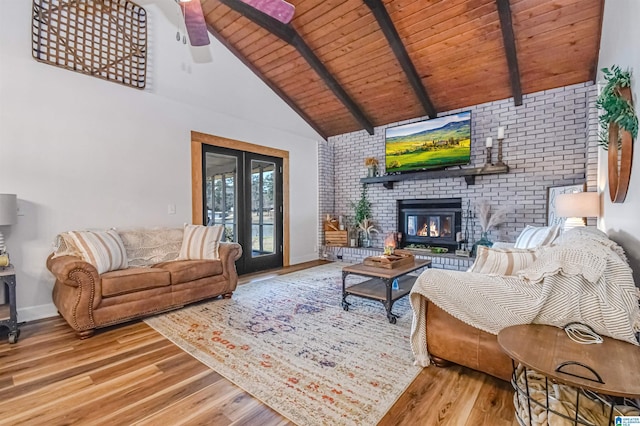 living area featuring ceiling fan, high vaulted ceiling, wooden ceiling, wood finished floors, and beam ceiling