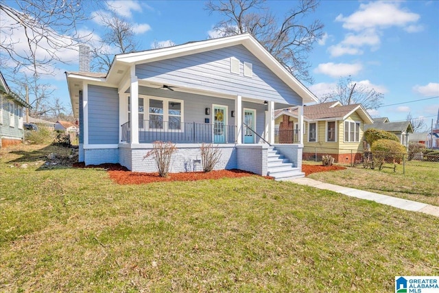 bungalow-style home featuring covered porch, a chimney, fence, and a front lawn