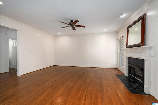 unfurnished living room with baseboards, ceiling fan, ornamental molding, wood finished floors, and a fireplace