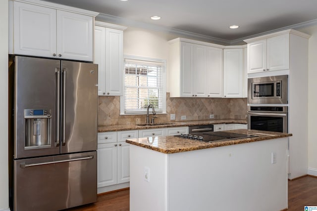 kitchen featuring dark wood-style floors, stainless steel appliances, a sink, and white cabinets