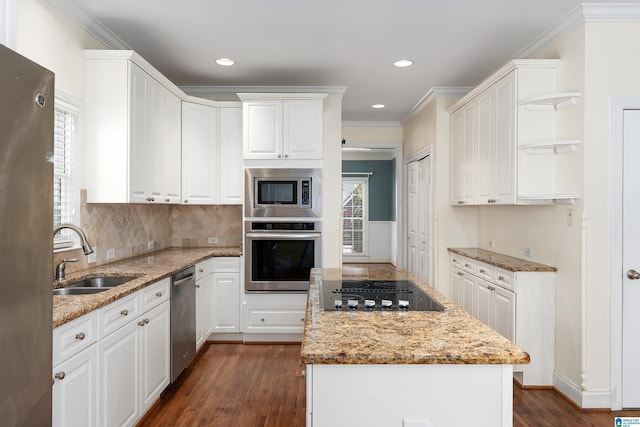 kitchen featuring stainless steel appliances, a kitchen island, a sink, and dark wood-style floors