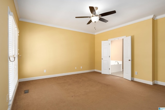 unfurnished bedroom with carpet, visible vents, ornamental molding, and baseboards