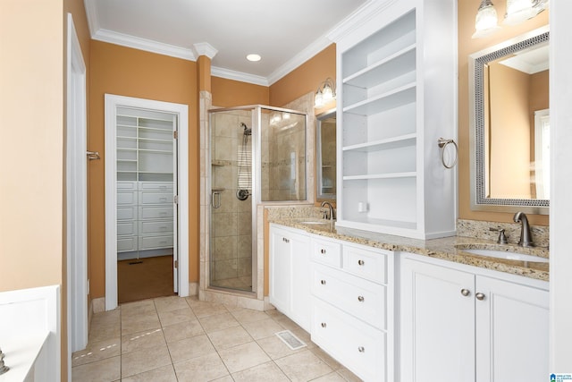 bathroom featuring a stall shower, a sink, visible vents, and a walk in closet