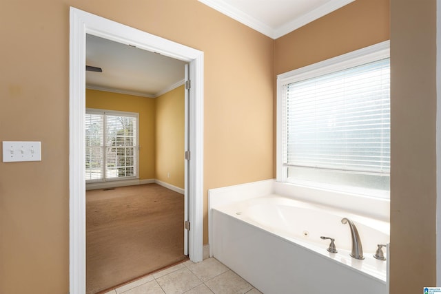 bathroom featuring baseboards, tile patterned flooring, a tub with jets, and crown molding