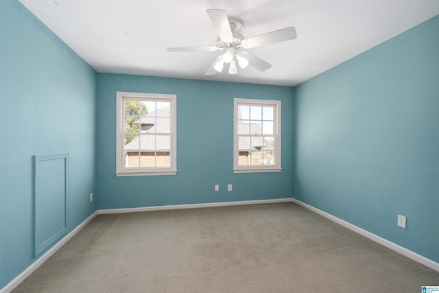 unfurnished room featuring baseboards, carpet, a ceiling fan, and a healthy amount of sunlight