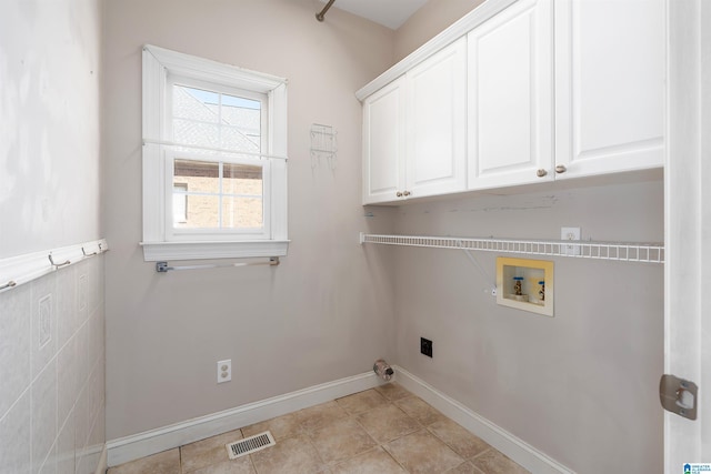 laundry room featuring hookup for an electric dryer, washer hookup, visible vents, baseboards, and cabinet space