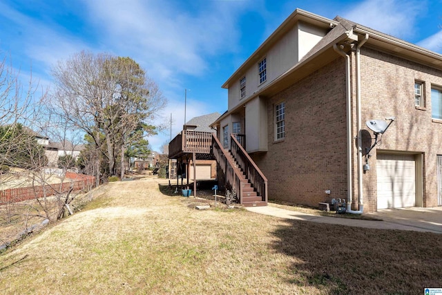 view of home's exterior featuring an attached garage, a yard, stairway, and brick siding