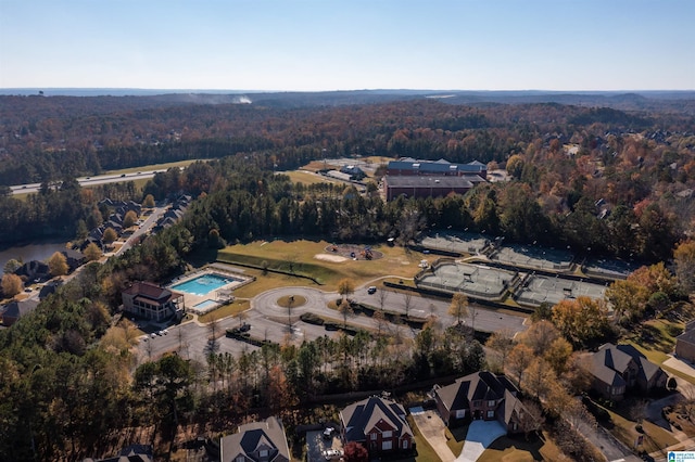 birds eye view of property featuring a forest view