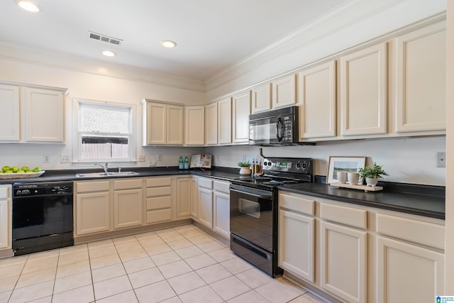 kitchen featuring black appliances, dark countertops, a sink, and visible vents