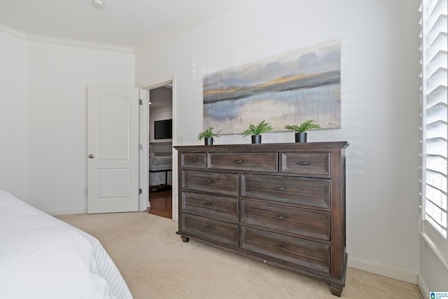 bedroom featuring ornamental molding, light colored carpet, and baseboards