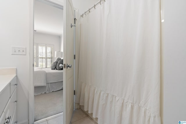 full bathroom featuring a shower with curtain, vanity, ensuite bath, and tile patterned floors