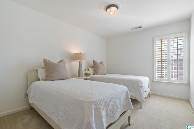 bedroom with baseboards, visible vents, and light colored carpet