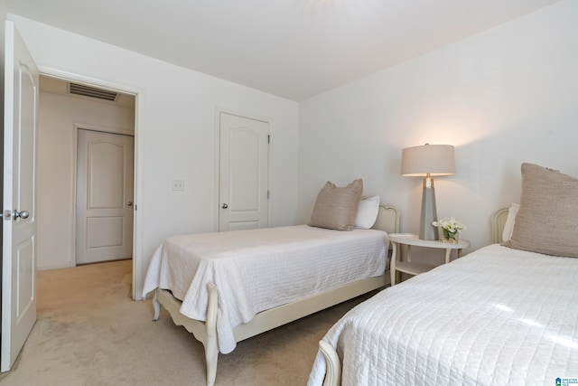 bedroom featuring light carpet and visible vents