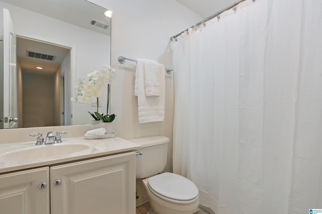 bathroom with toilet, visible vents, and vanity