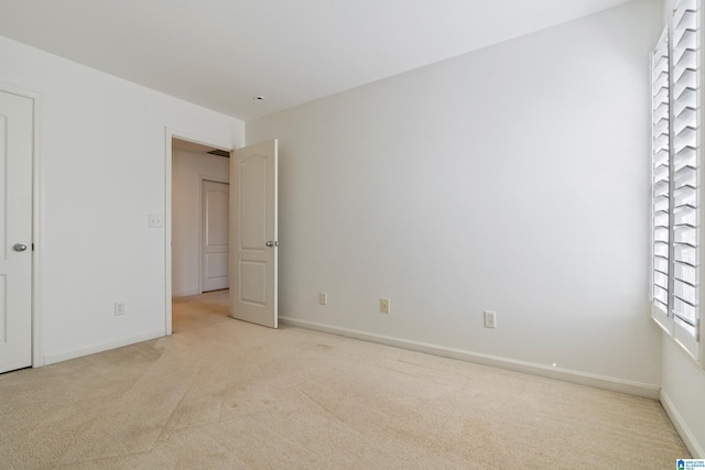 unfurnished bedroom with carpet floors and baseboards