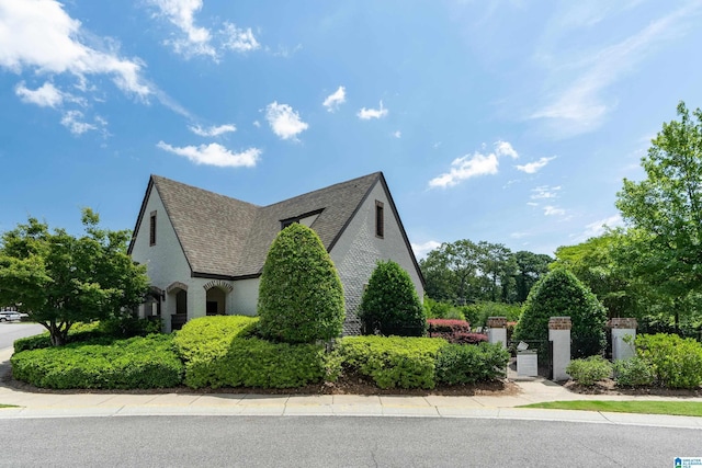 view of side of home featuring roof with shingles