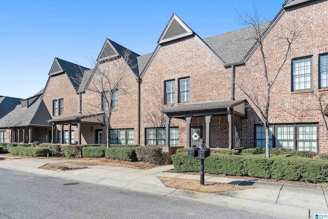 townhome / multi-family property featuring brick siding