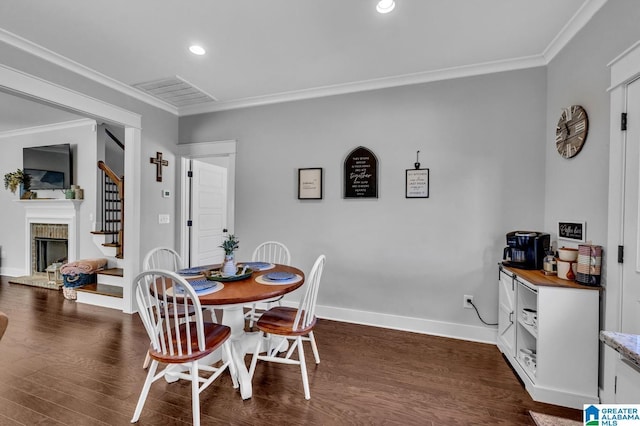 dining area with stairs, ornamental molding, and dark wood-type flooring