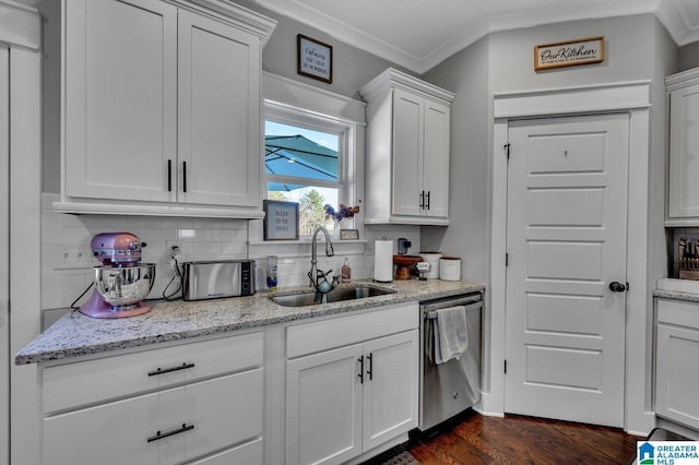 kitchen featuring dark wood finished floors, white cabinets, backsplash, stainless steel dishwasher, and a sink