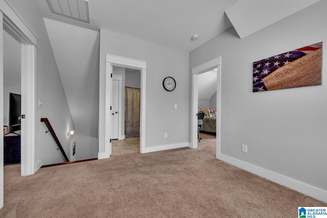 unfurnished bedroom featuring light carpet, visible vents, and baseboards